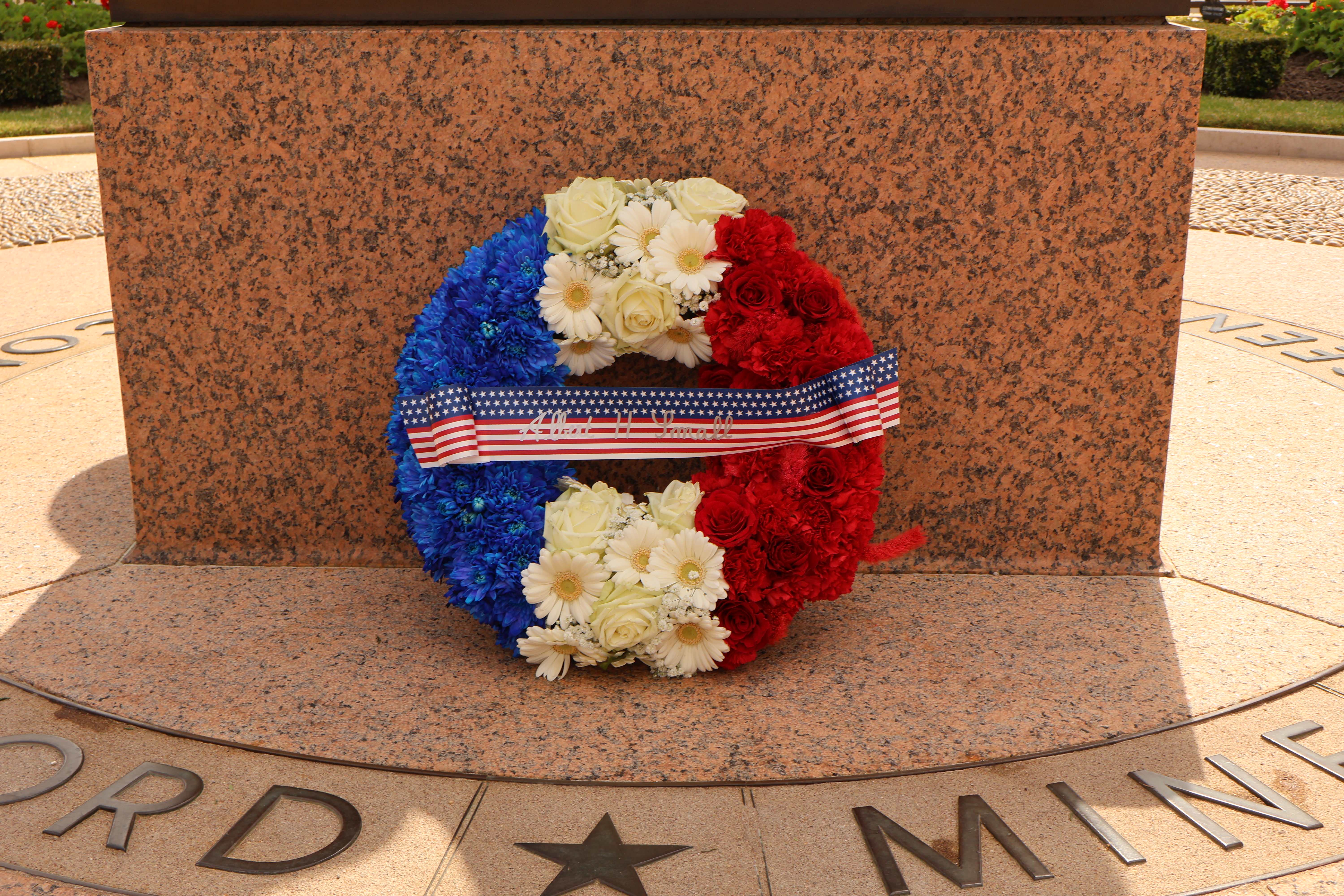 Wreath at the base of a statue in Normandy
