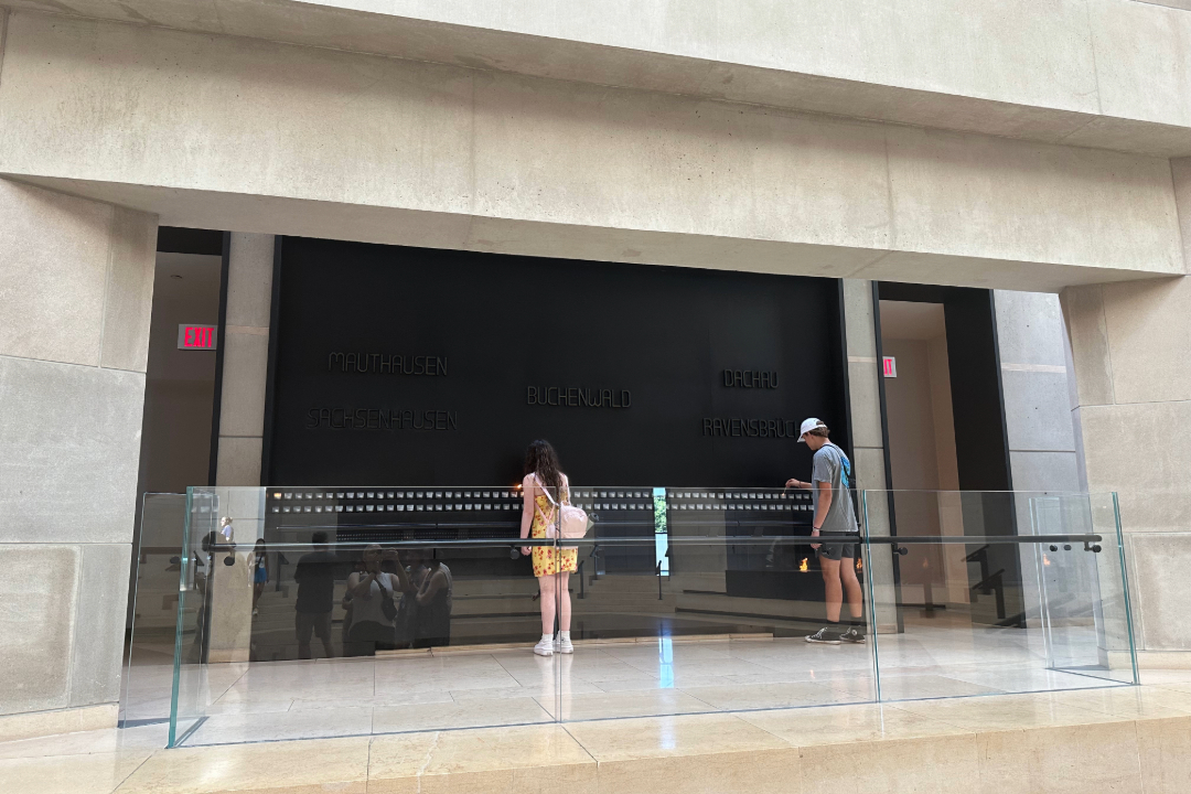 People lighting candles at the Holocaust Museum